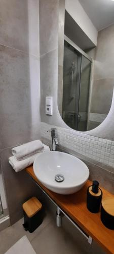 a bathroom with a white sink and a mirror at Apartament Milonga in Krakow