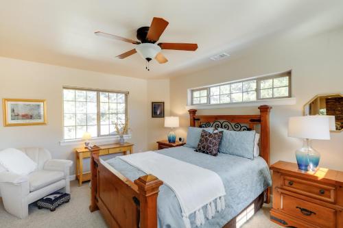 a bedroom with a bed and a ceiling fan at Cozy Arizona Retreat with Fireplace, Patio and Grill! in Flagstaff