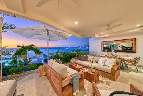 a living room with a view of the ocean at Maxwell Residences at Indah in Puerto Vallarta