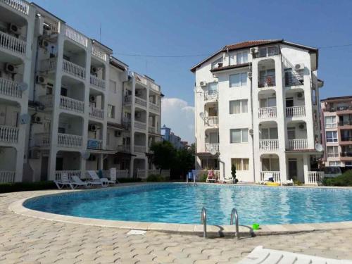 a swimming pool in front of two apartment buildings at Sunny Beach Apartment - Kuban / Bravo 5 in Sunny Beach