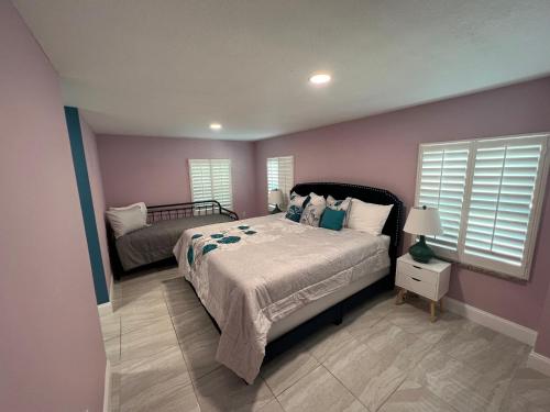 a bedroom with a large bed and a window at Atlantic Shores Motel in Daytona Beach