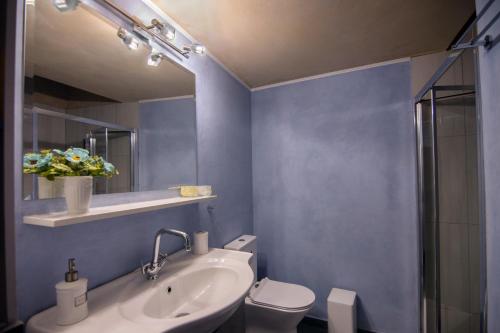 a bathroom with a sink and a toilet and a mirror at MintHouse Holiday Home in  Episkopi (Chania)