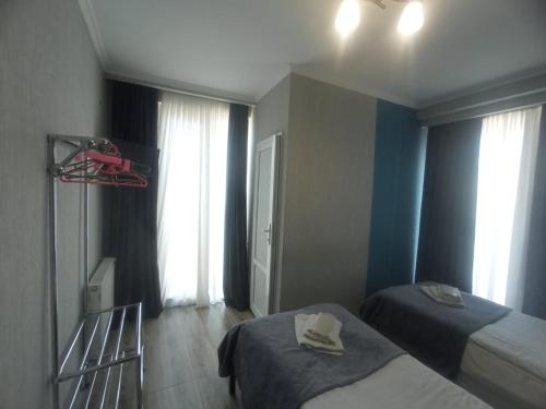 a hotel room with two beds with towels on them at Sweet home in Tbilisi City