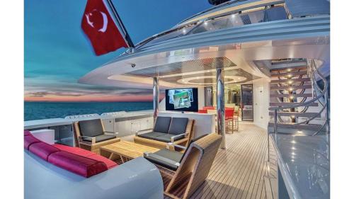 a deck on a yacht with chairs and a table at MERMAID in Bodrum City