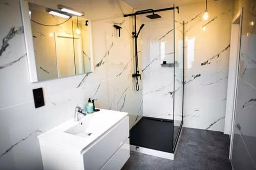 een badkamer met een wastafel en een glazen douche bij Barotel - Bed & Dinner in Floreffe