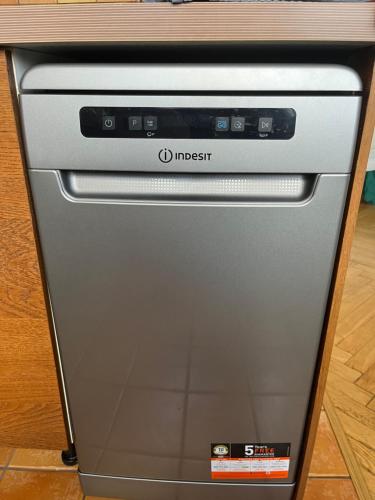 a dishwasher sitting under a counter in a kitchen at Wilson Apartment in Warsaw