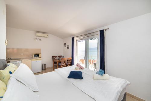 a bedroom with two beds with a view of the ocean at Apartments Tilda in Brist
