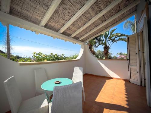 a balcony with a table and chairs and a view of the ocean at Borgo Marino Plemmirio in Siracusa