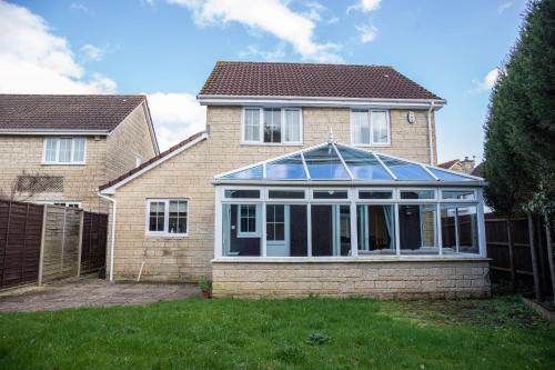 a house with a conservatory on the front of it at May Disc - Long Stay - Contractors in Bristol
