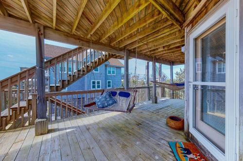 a porch with a bench on a wooden deck at Stellar Vista in Avon