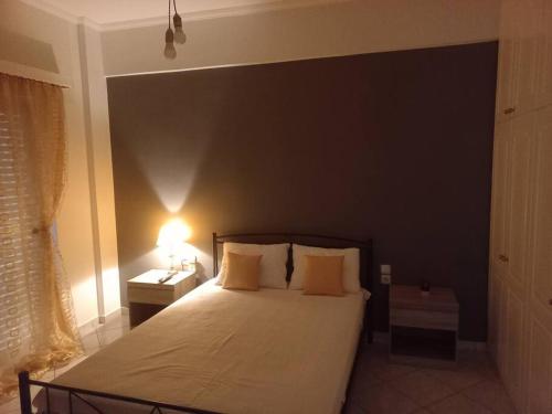 a bedroom with a large bed with a black wall at Stefkas apartment1 in Patra