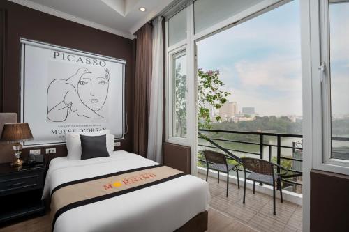 a hotel room with a bed and a large window at Hanoi Morning Hotel in Hanoi