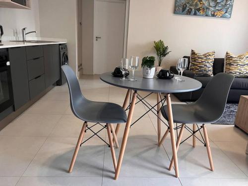 a table and two chairs in a living room at 93 on new unique and classy in Midrand