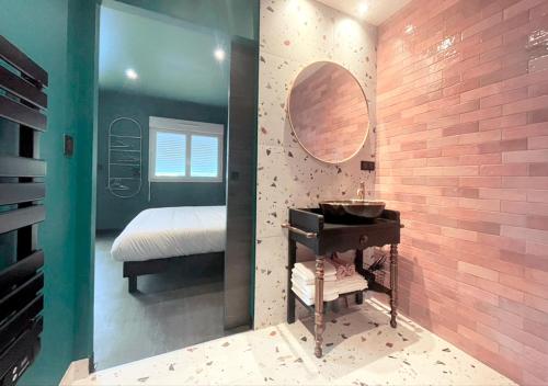 a bathroom with a sink and a mirror at NUITS D'EXIL in Gérardmer