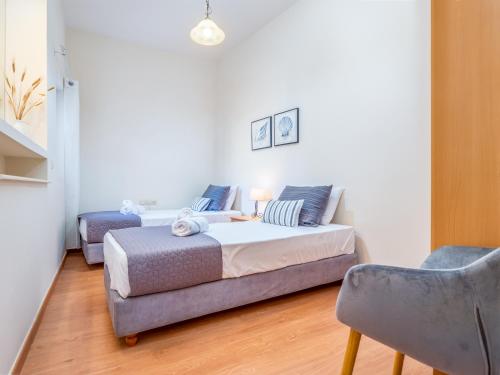 a bedroom with a bed and a couch and a chair at Casteli Stone Residence in Kissamos