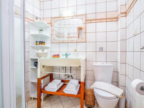 a bathroom with a toilet and a sink at Casteli Stone Residence in Kissamos