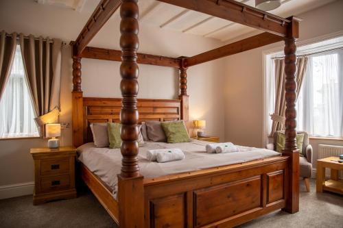 a bedroom with a large wooden bed in a room at Silverlands Guest House in Torquay