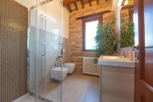 y baño con ducha, aseo y lavamanos. en Casale Vincenzo Country House, en Collecorvino