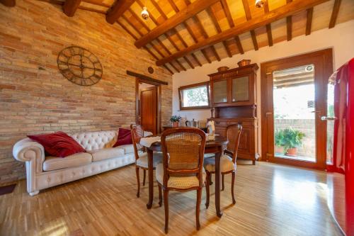 a living room with a couch and a table at Casale Vincenzo Country House in Collecorvino