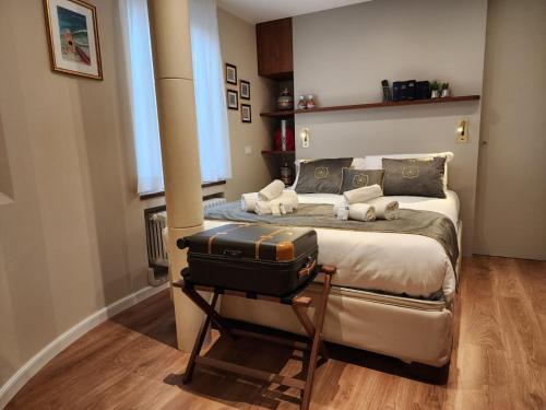 1 dormitorio con 1 cama y 1 maleta en una mesa en Charming stay in Roma - Luxury Holiday Apartment, en Roma