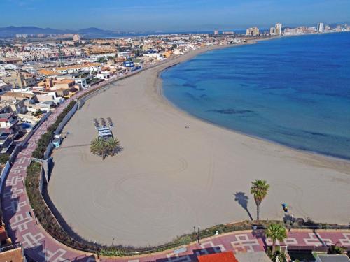 an aerial view of a beach with palm trees and the ocean at CABO DE PALOS ATICO LA GALERA parking in Cabo de Palos