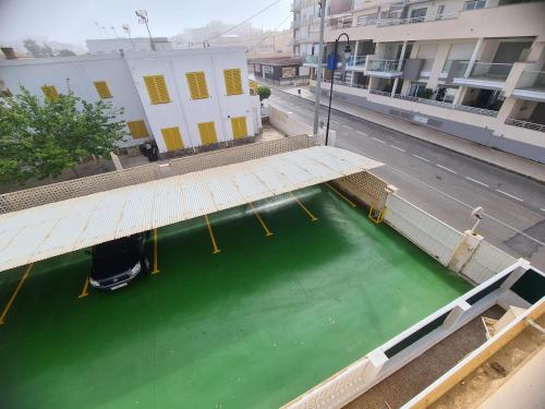 a large pool of green water on a city street at CABO DE PALOS ATICO LA GALERA parking in Cabo de Palos