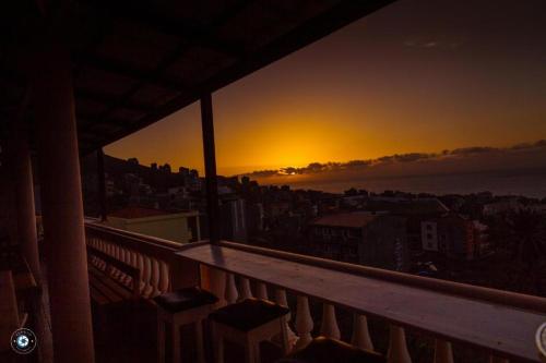 a view of a sunset from the balcony of a building at Kolina D´Sol in Ponta do Sol