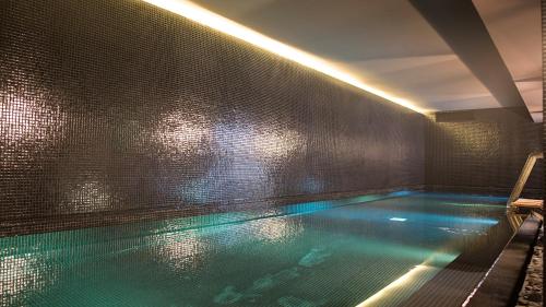a large swimming pool in a room with a window at Hyatt Centric Montevideo in Montevideo