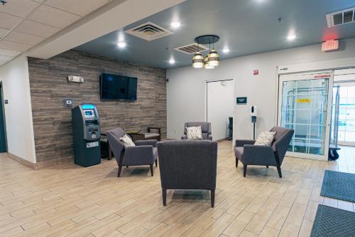 a waiting room with chairs and a pay phone at Candlewood Suites Merrillville by IHG in Merrillville