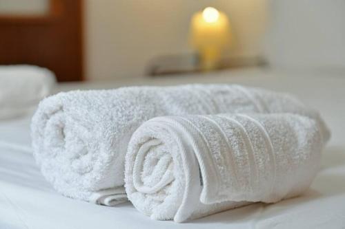 a white towel sitting on top of a bed at Maria's House in Hydra