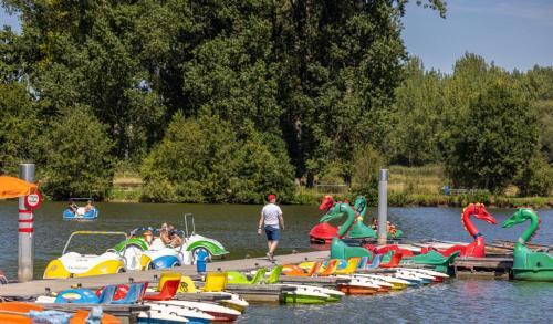 a bunch of boats are lined up on a dock at Villa Blue Garden B&B Vlaamse Ardennen nabij Pairi Daiza in Geraardsbergen