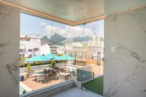 a view of a balcony with tables and umbrellas at Royal Regency Palace Hotel in Rio de Janeiro