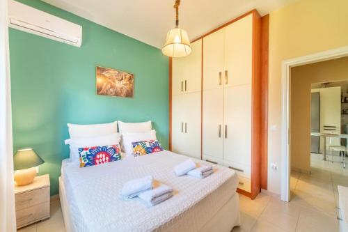 a bedroom with a bed with a blue wall at Irini's country house in Gouvia