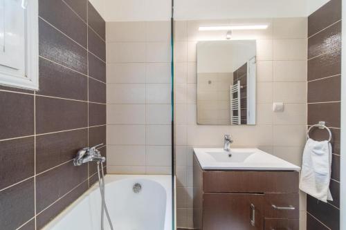 a bathroom with a tub and a sink and a mirror at Irini's country house in Gouvia