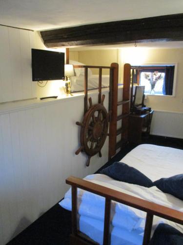 a bedroom with two bunk beds and a tv at Blue Cabin Bridge Stores in Fritton Norfolk