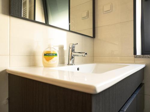 a bathroom sink with a bottle of soap on it at Casa Malagueira in Fafião