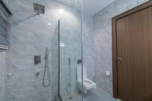 a bathroom with a shower with a toilet in it at Tranquila Hotels and Suites Abuja in Abuja