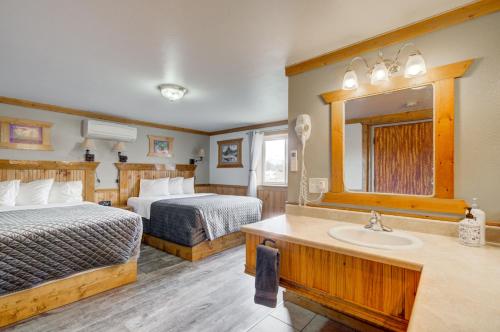 a hotel room with two beds and a sink at Livingston Inn in Livingston