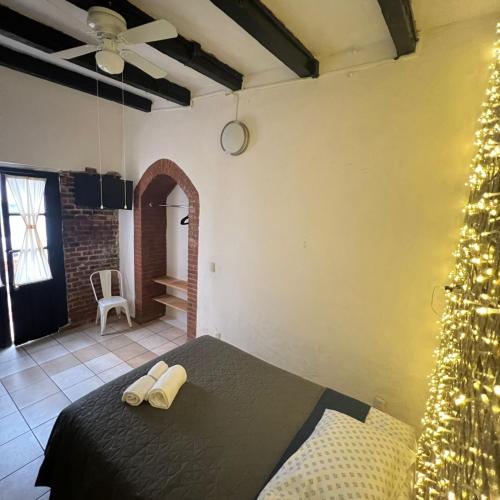 a bedroom with a christmas tree in a room at Hostal Luna 49 in Querétaro