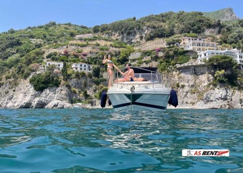 two people jumping off a boat in the water at AIR OF SEA ON BOAT in Salerno