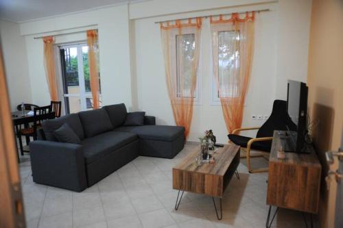 a living room with a couch and a coffee table at SAN FLORAN in Áyios Flóros