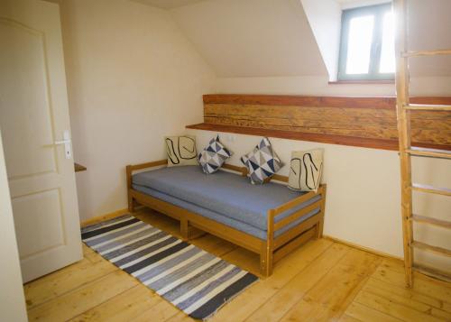 a bedroom with a bunk bed and a ladder at Válaszút Fogadó in Păuleni-Ciuc