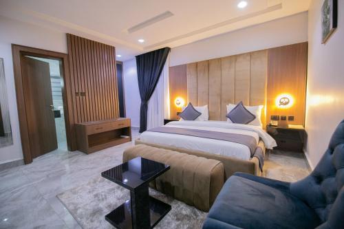 a hotel room with a bed and a couch at Tranquila Hotels and Suites Abuja in Abuja