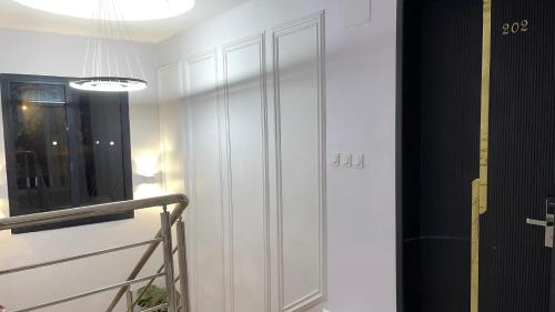a hallway with a white door and a window at Suna' a Home Bonapriso in Douala