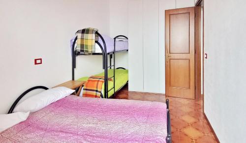 a bedroom with two bunk beds and a door at Mountain view charming apartment in Moggio
