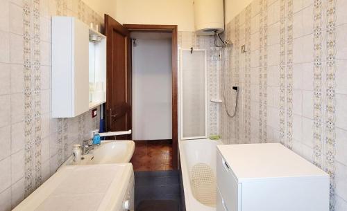 a small bathroom with a sink and a toilet at Mountain view charming apartment in Moggio