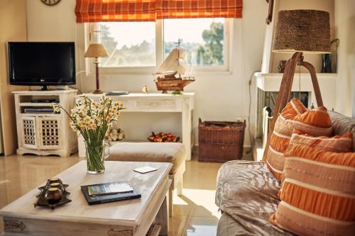 a living room with a couch and a table at Villa Contessa Irini in Plános