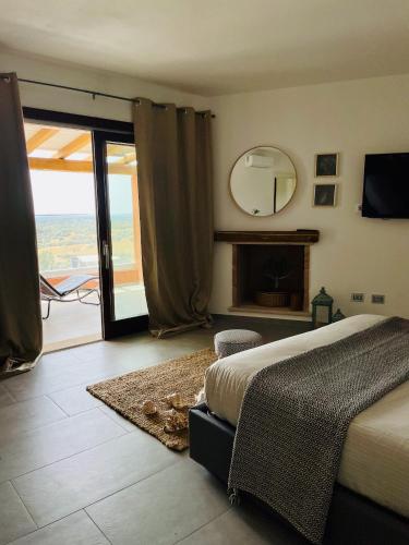 a bedroom with a bed and a mirror on the wall at bella vista Villasimius in Villasimius