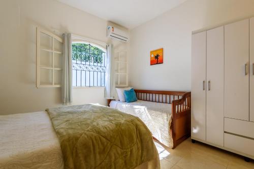 Katil atau katil-katil dalam bilik di Village Itaúna Inn - Casas de Temporada para Famílias