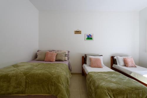 Katil atau katil-katil dalam bilik di Village Itaúna Inn - Casas de Temporada para Famílias